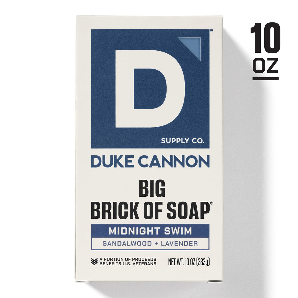 Duke Cannon soap being lathered on a loofah for quick cleansing.