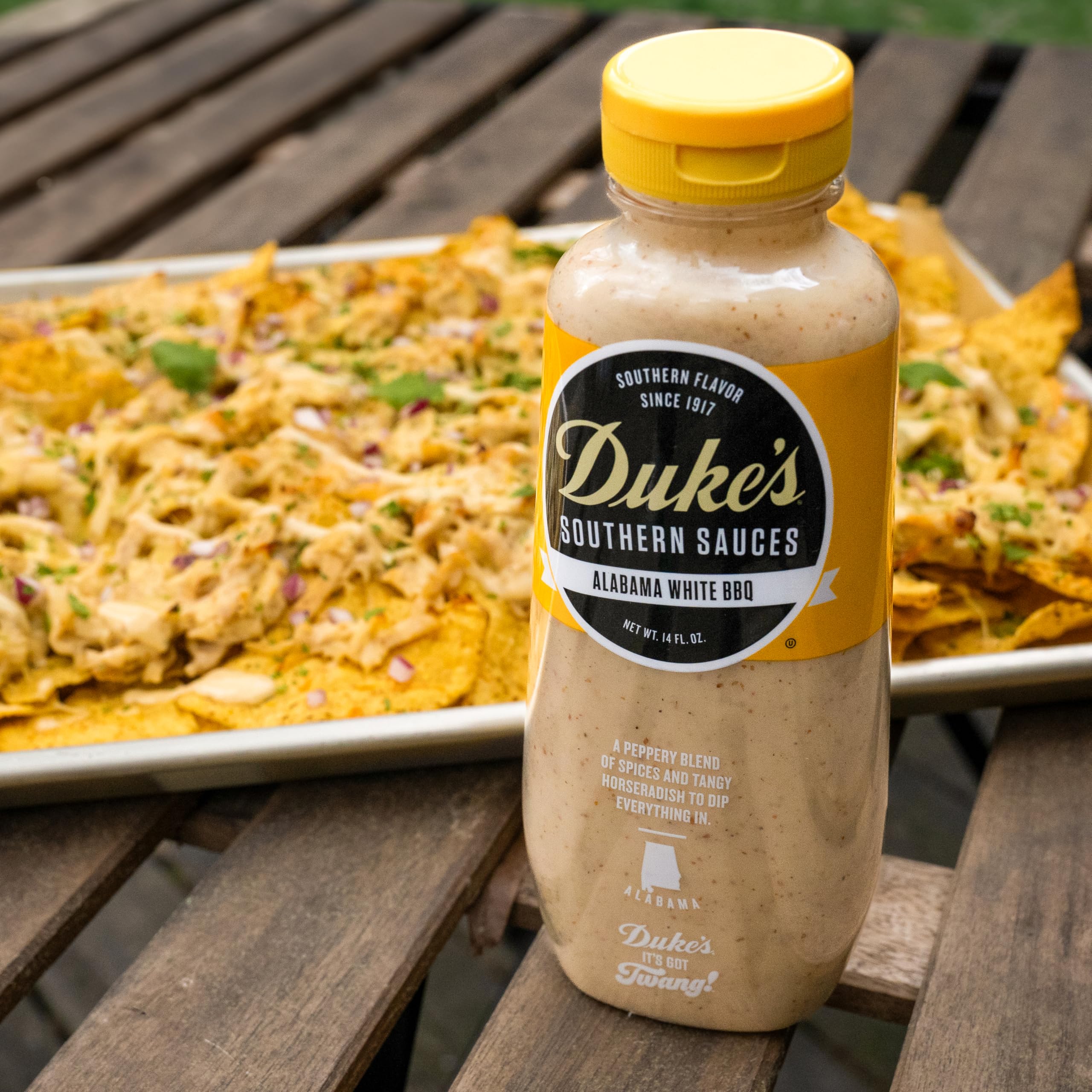 Duke’s Alabama White Sauce pour close-up highlighting tangy horseradish kick.