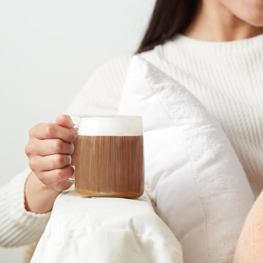 Dunkin-branded mug beside a steaming cup of medium roast coffee.