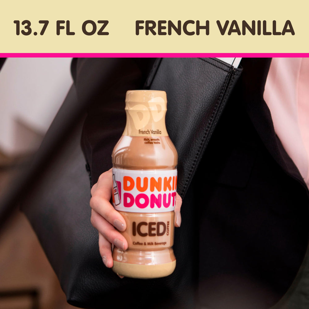 Dunkin' Iced coffee glass with bottle, smooth coffee-milk blend ready to sip.