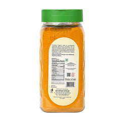 DWARAKA turmeric powder in bowl adds color and flavor to curries and beverages.