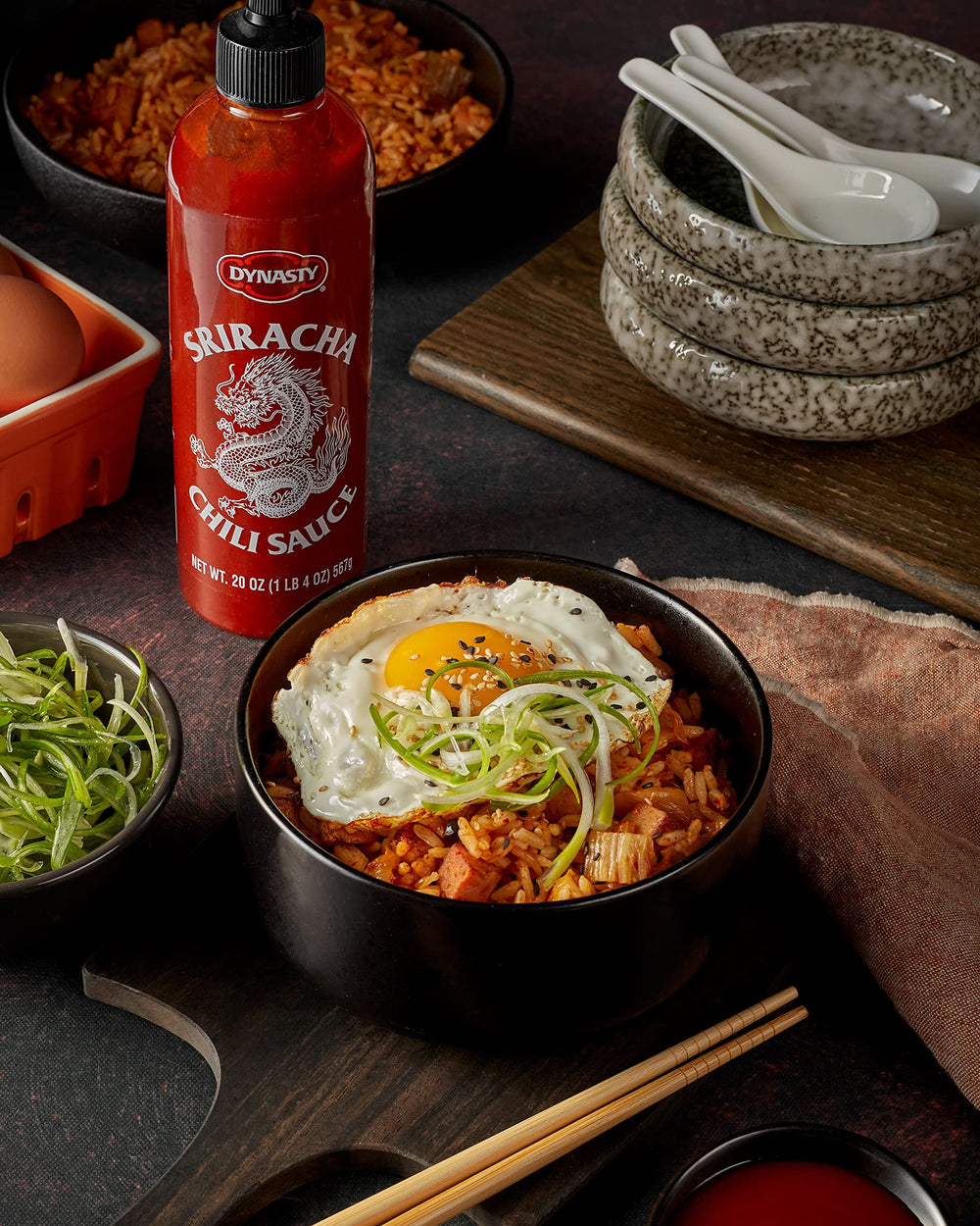 Dynasty Sriracha bottle with dipping sauce scene for appetizers.