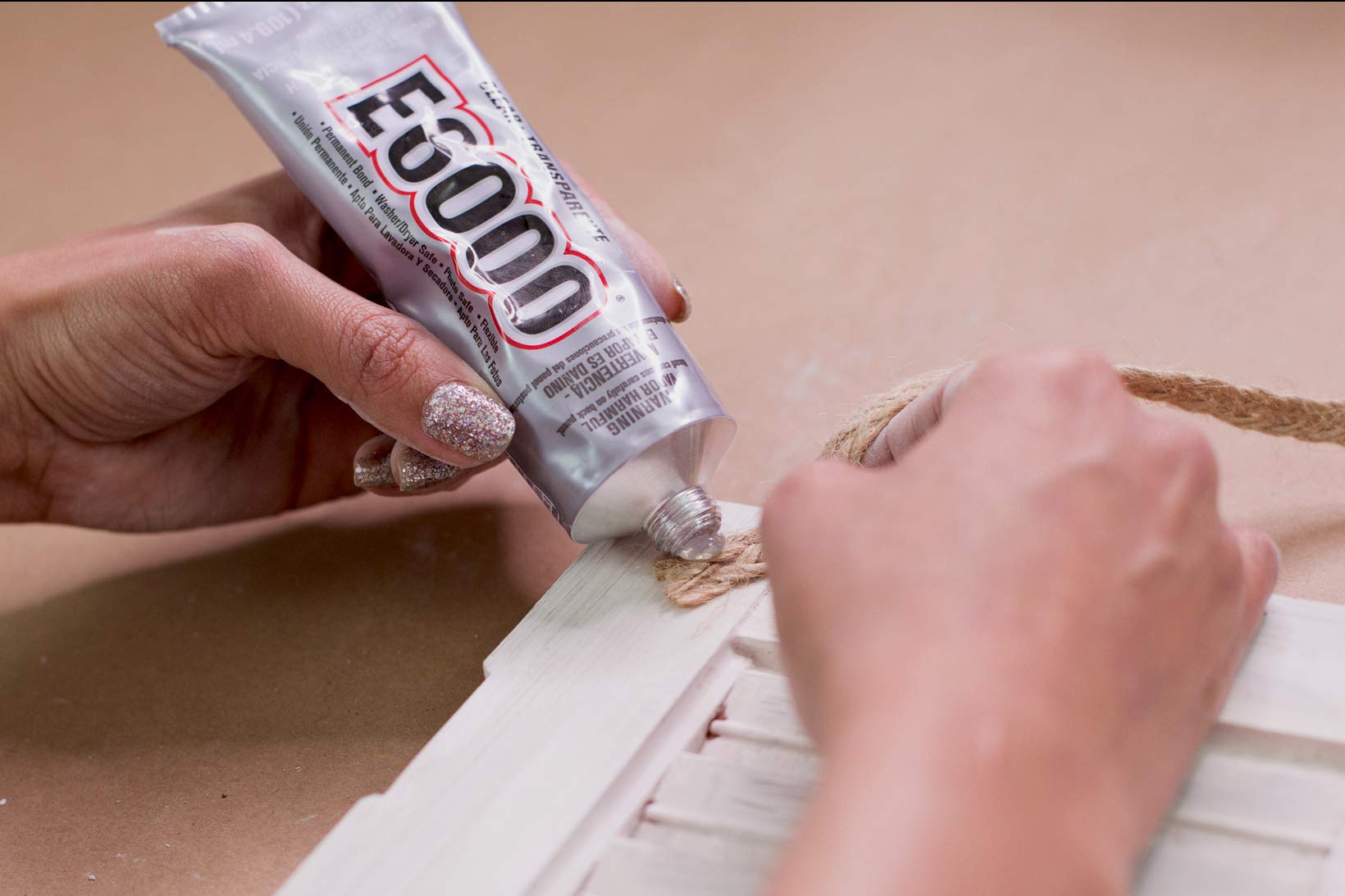 E6000 Craft Adhesive packaging highlights indoor/outdoor use and odor-free formula.