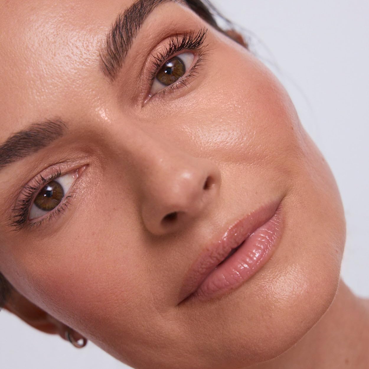 EarthsCure Glow Trio blush-stick swatch on cheek for subtle glow.