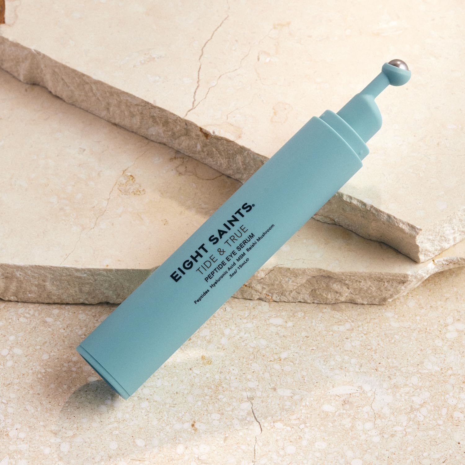 Eight Saints Tide & True Eye Serum roller ball in action delivering a cooling depuff under the eye.