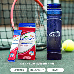 Electrolit powder dissolving in water to create a refreshing fruit punch beverage.