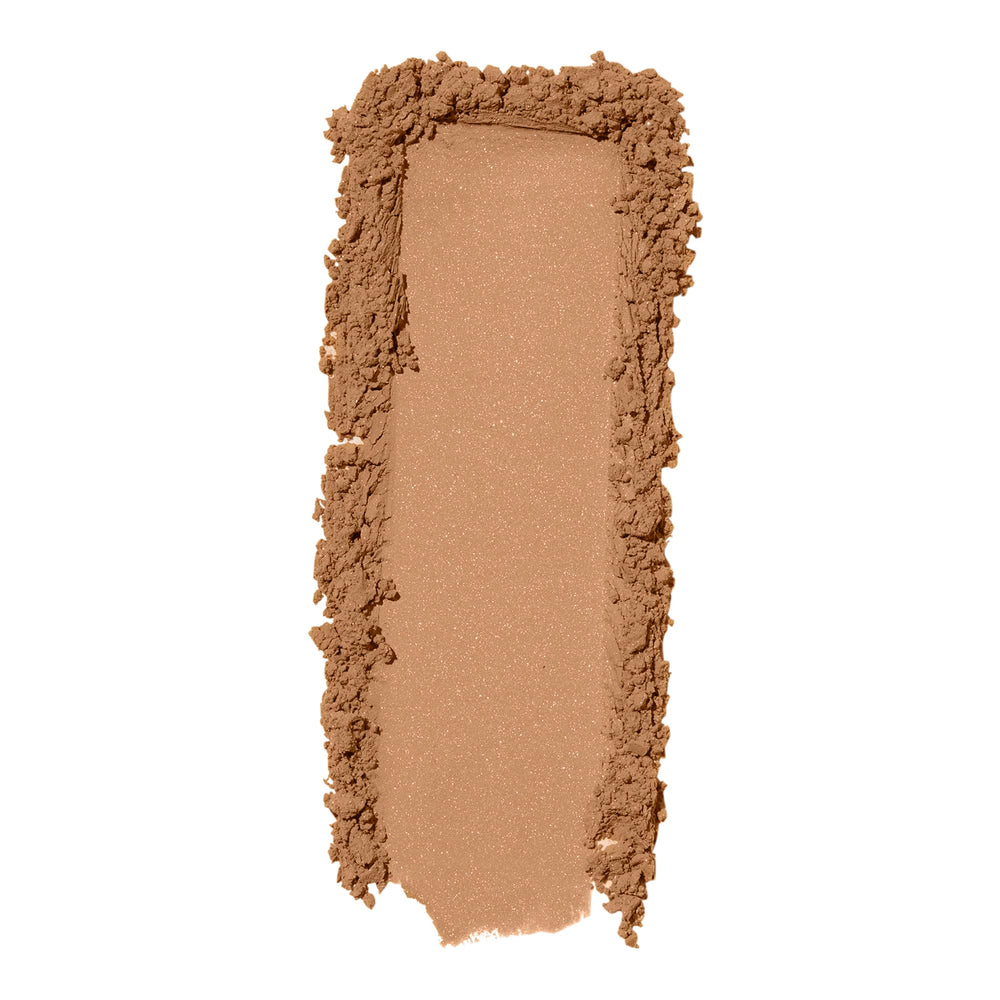 Close-up of applying e.l.f. Halo Glow powder to skin for a long-lasting finish.