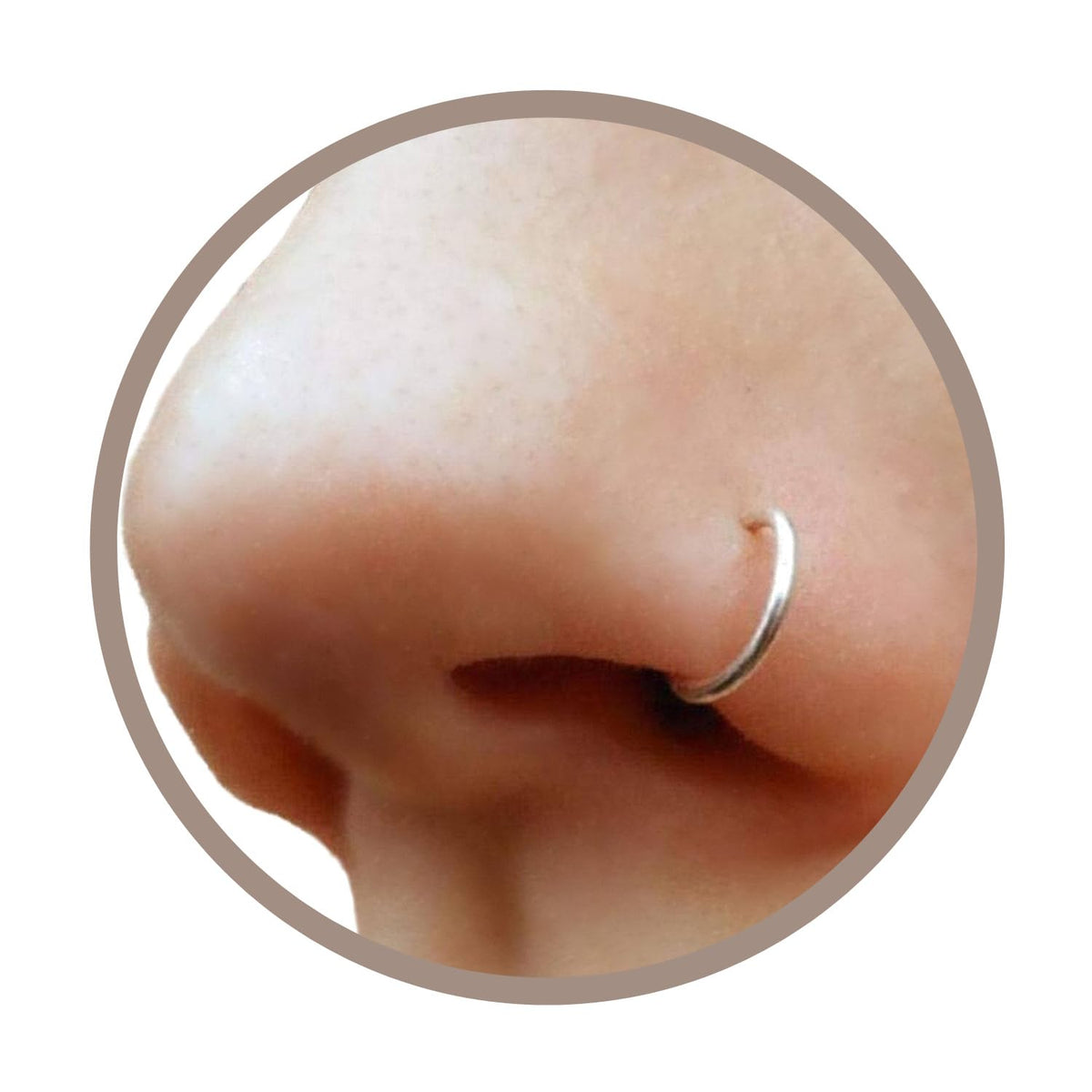 EnCharmed clip-on nose ring in silver, close-up of delicate faux piercing look.