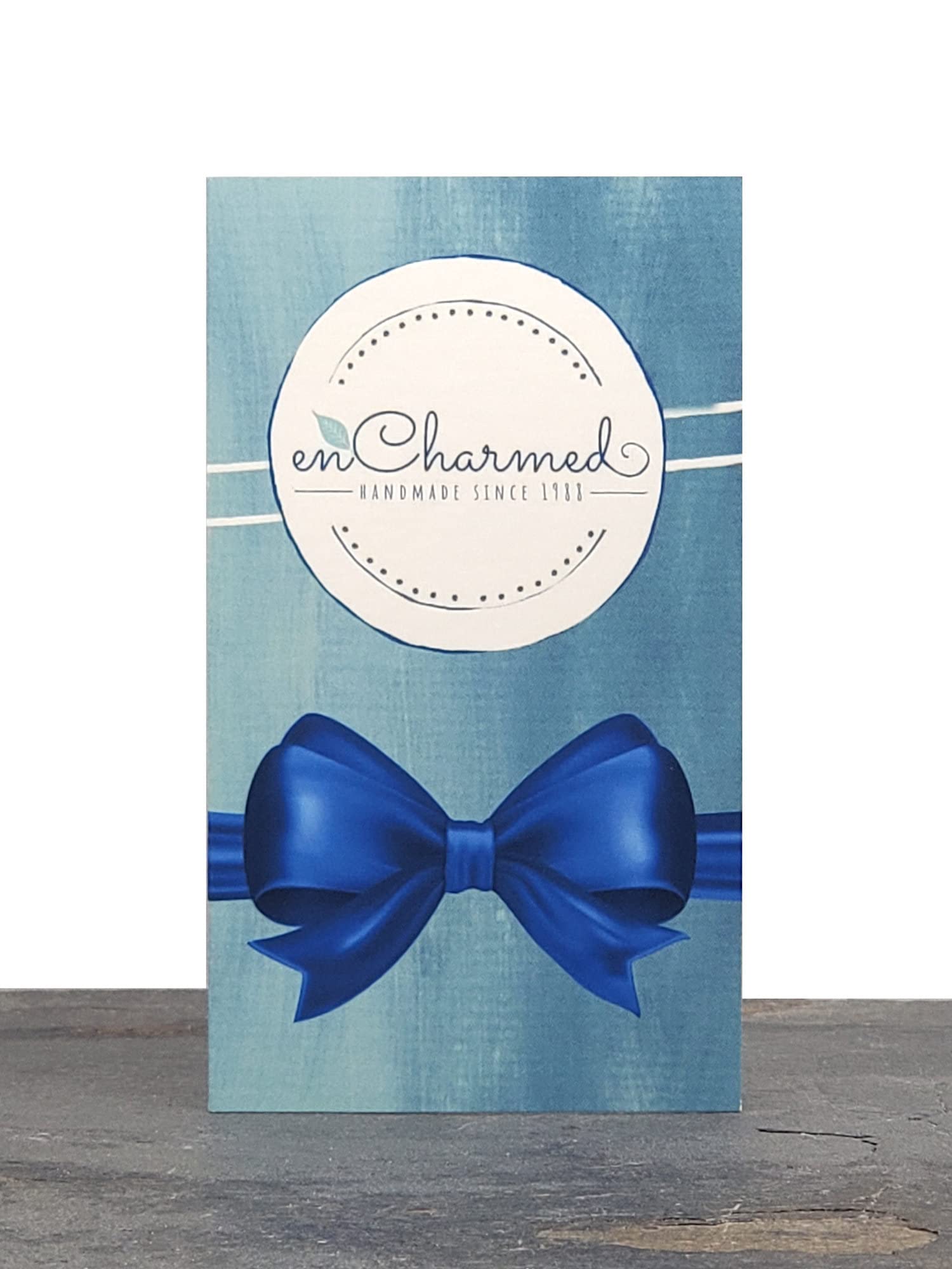 EnCharmed packaging with gift card and care instructions.