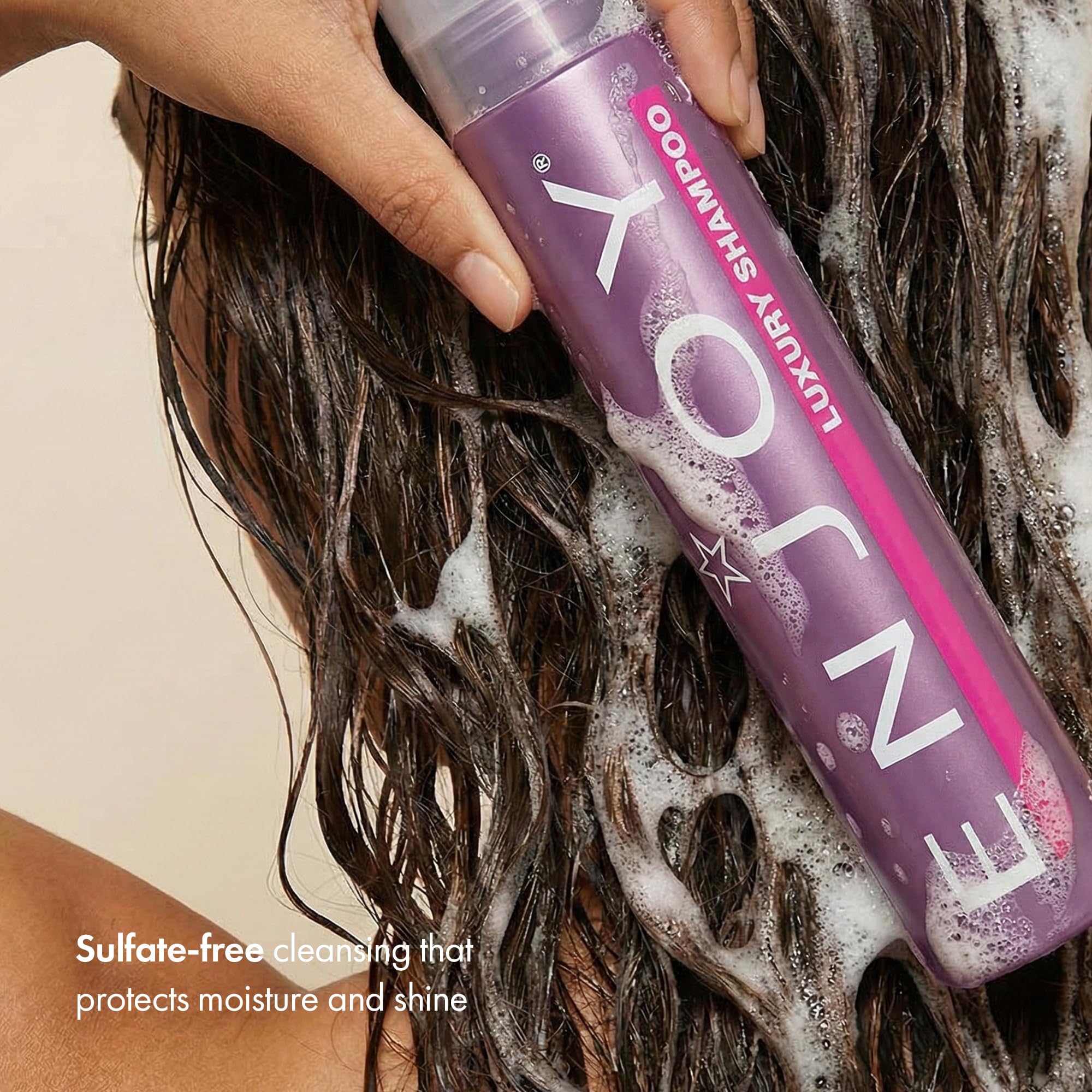 Enjoy Luxury Conditioner bottle dispense demonstrates hydrating care for frizz-prone hair.