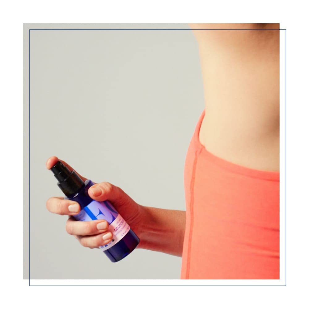 Lavender flowers beside EO Lavender Shower Gel bottle