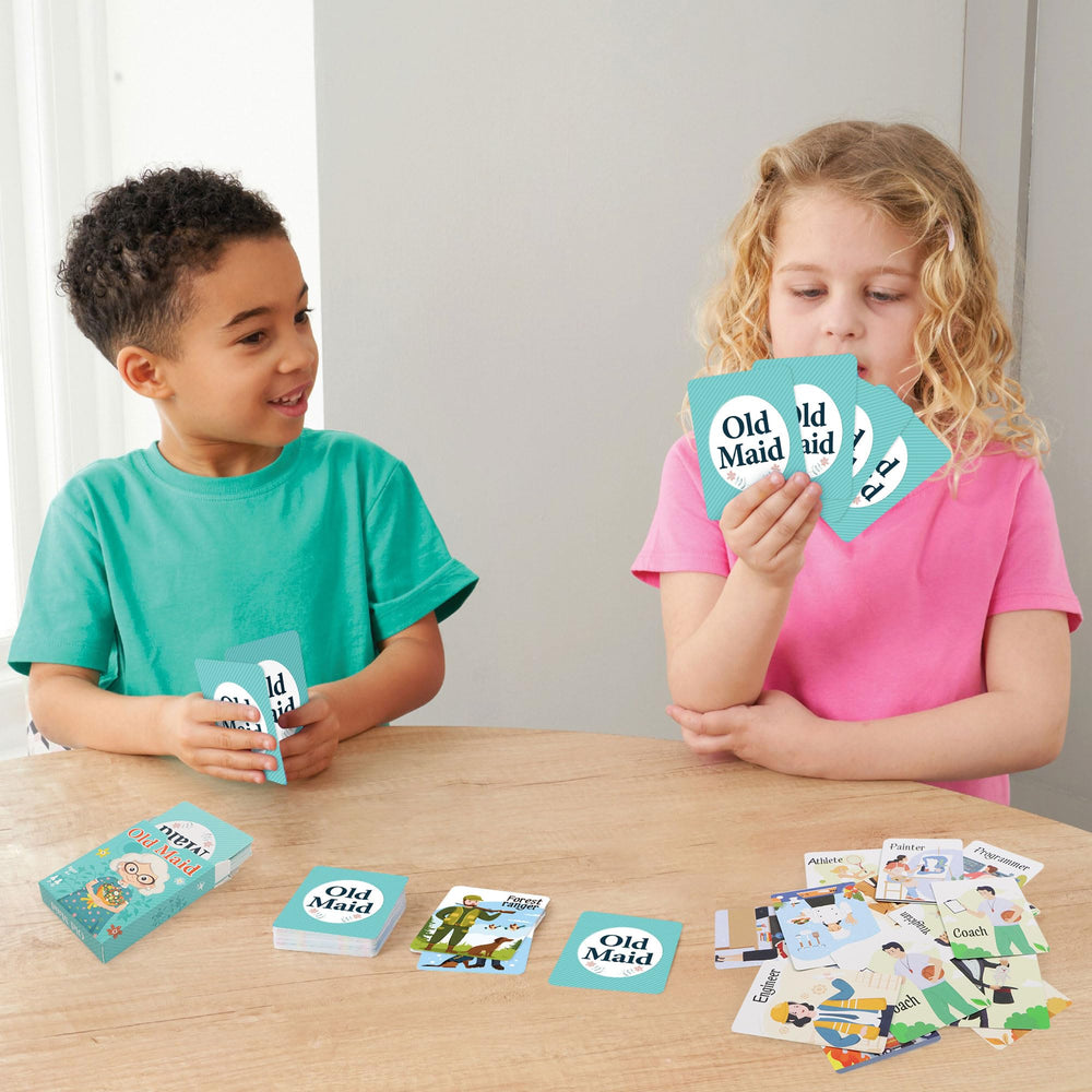 Etyishe kids playing card game around a table during a break