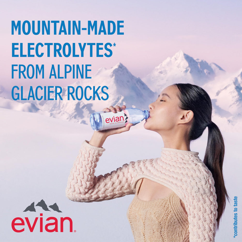 evian bottle pouring into a glass for refreshment