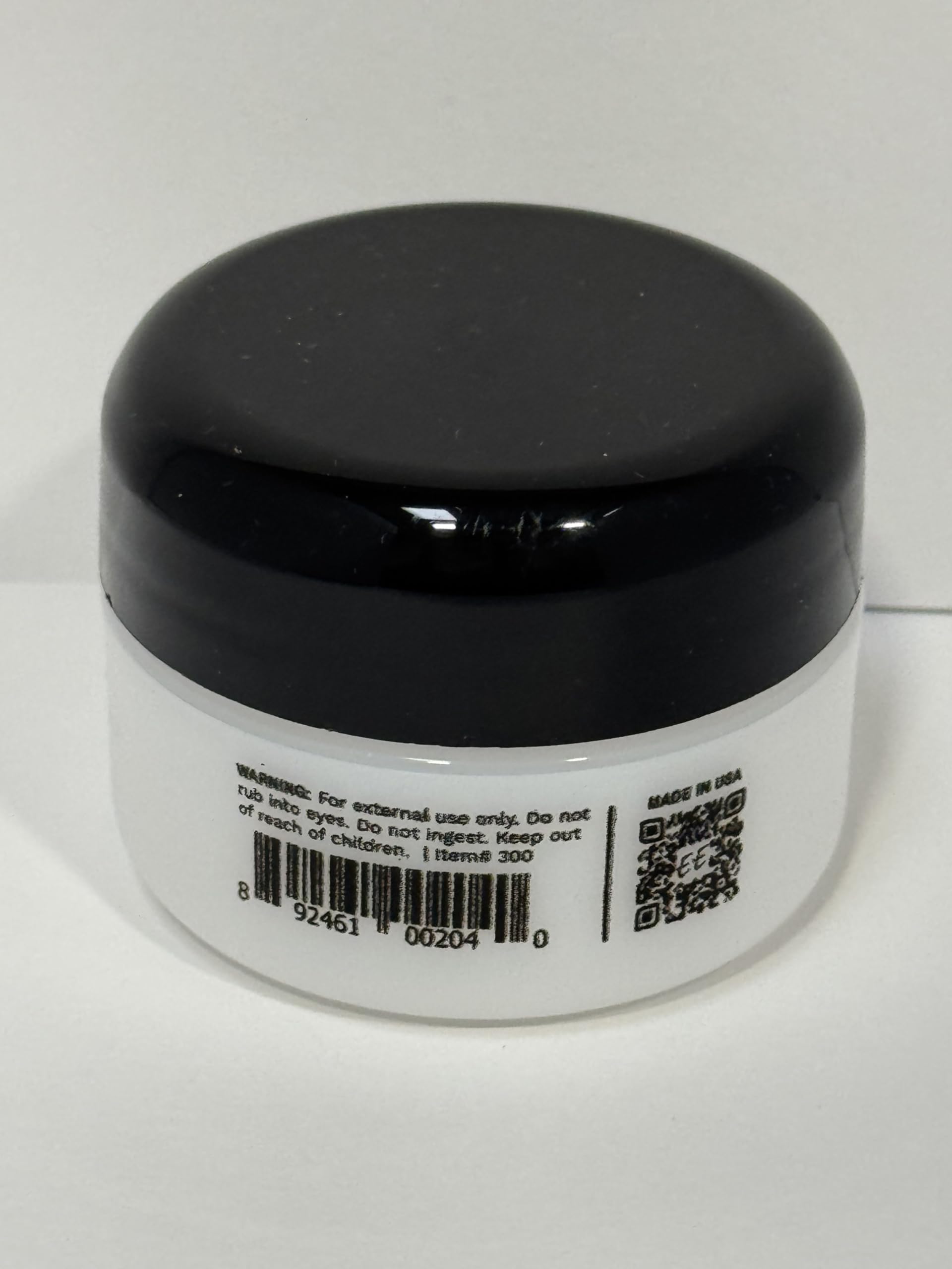 Applying Eye Envy powder around the eye area with the applicator for controlled use.