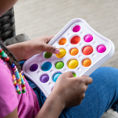 Dimpl Pops features two bubble sizes for varied play and fine motor practice.