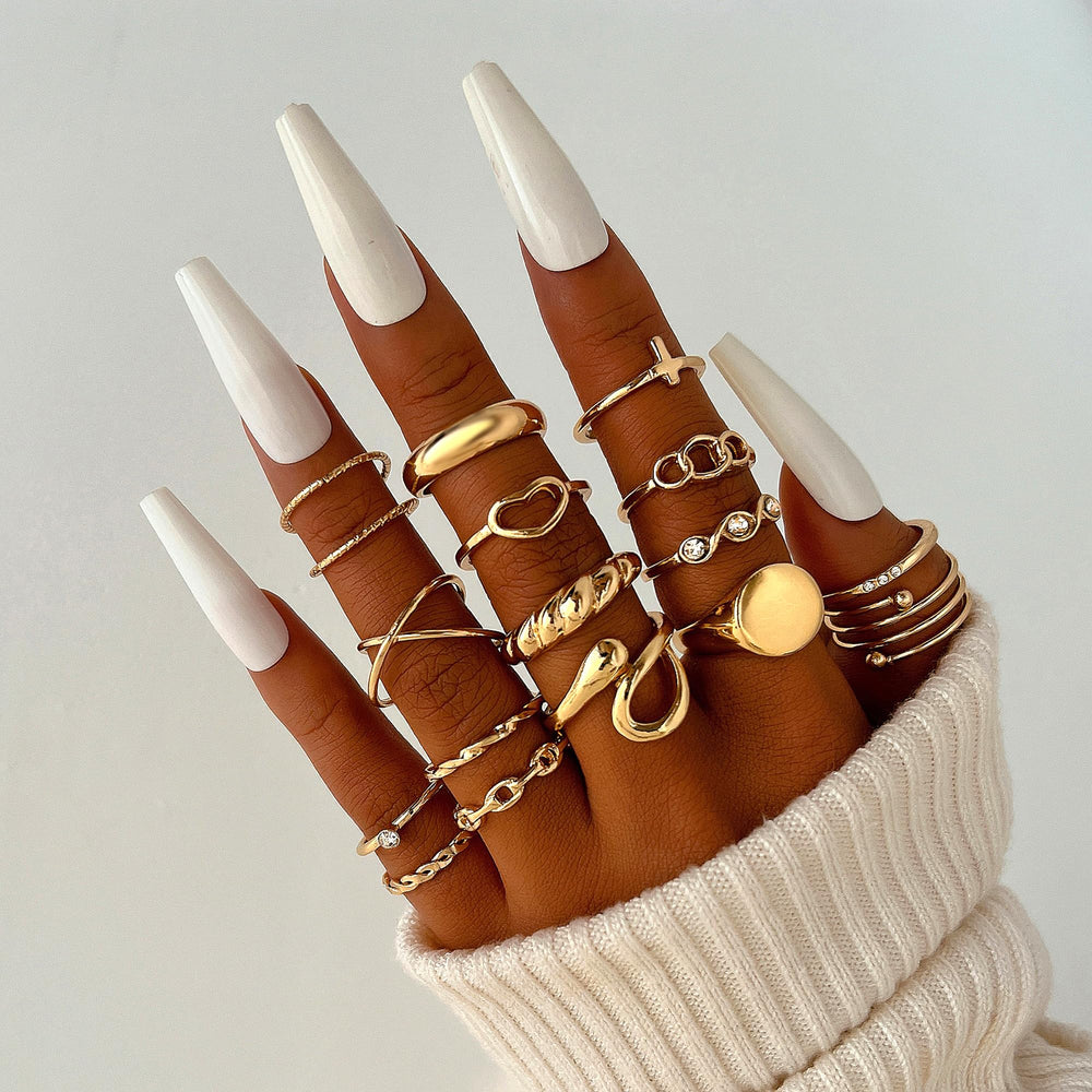 FAXHION gold knuckle rings close-up highlights CZ sparkle and chic style.