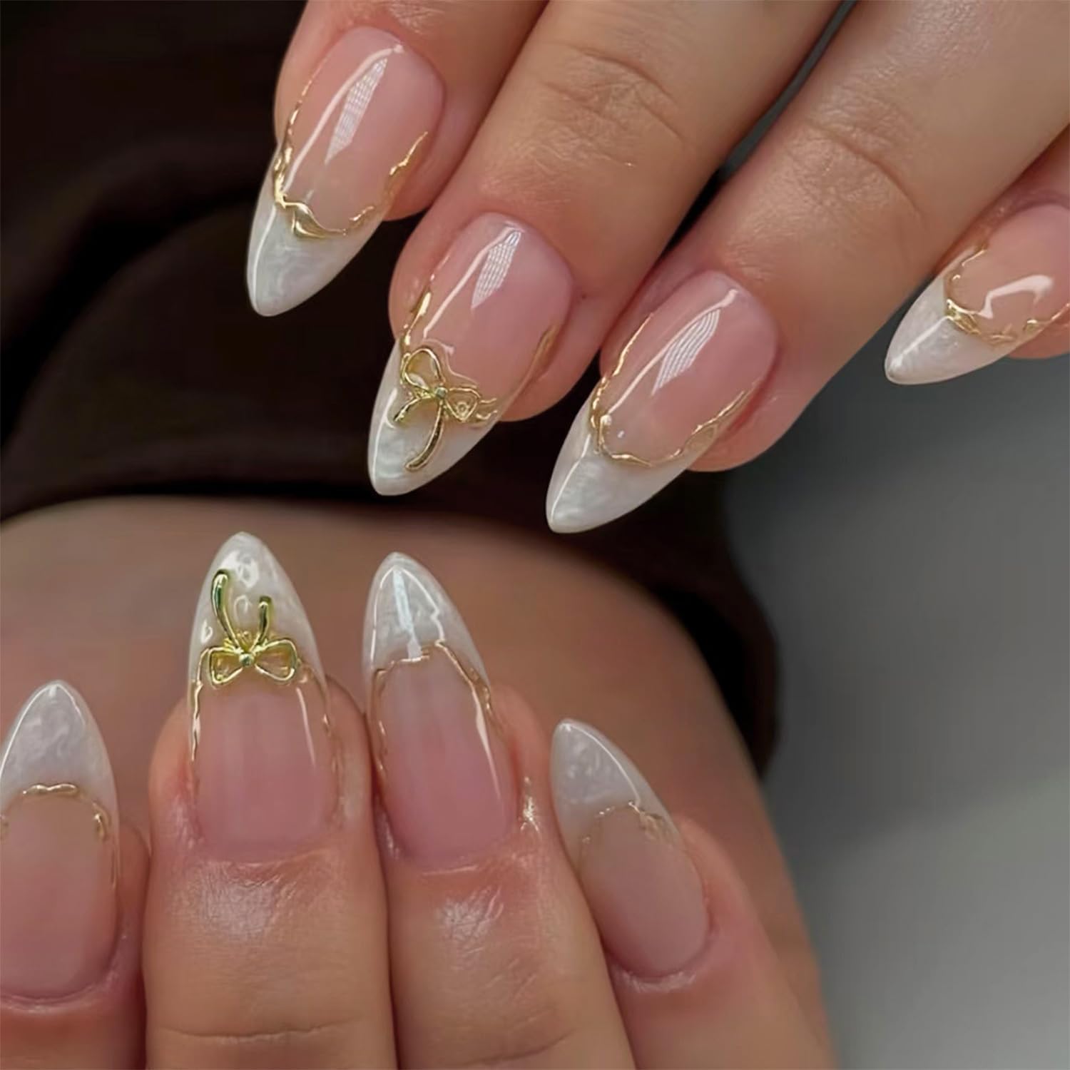 Almond nails with gold line accents for luxe flair.