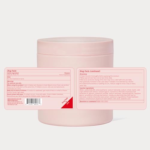 First Aid Beauty acne pads on counter with towel.