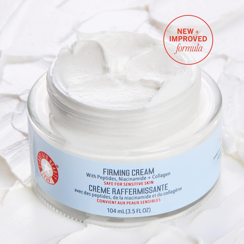 First Aid Beauty firming cream jar closeup highlights creamy texture for easy application.