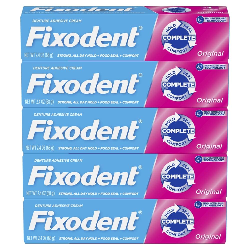 Fixodent Original strong hold adhesive applied to dentures for long wear.