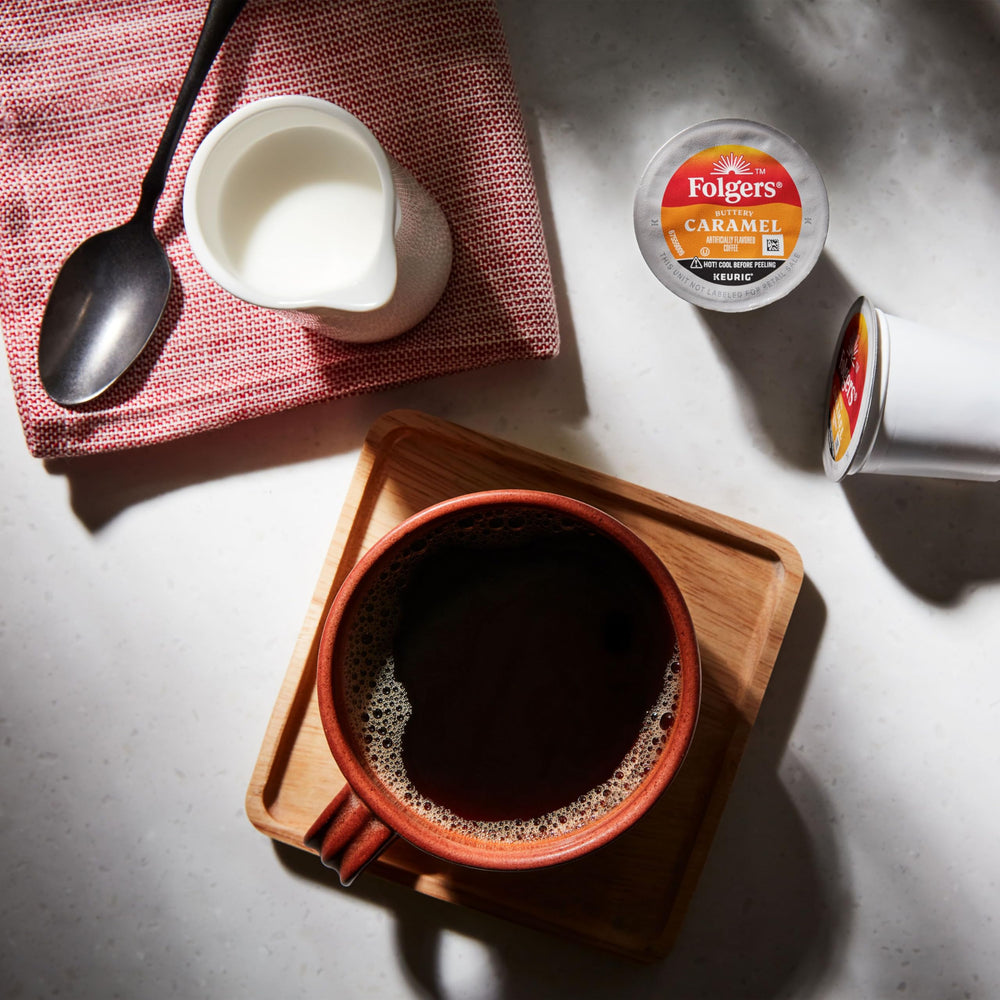 A steaming Folgers Buttery Caramel cup poured from a Keurig brew.