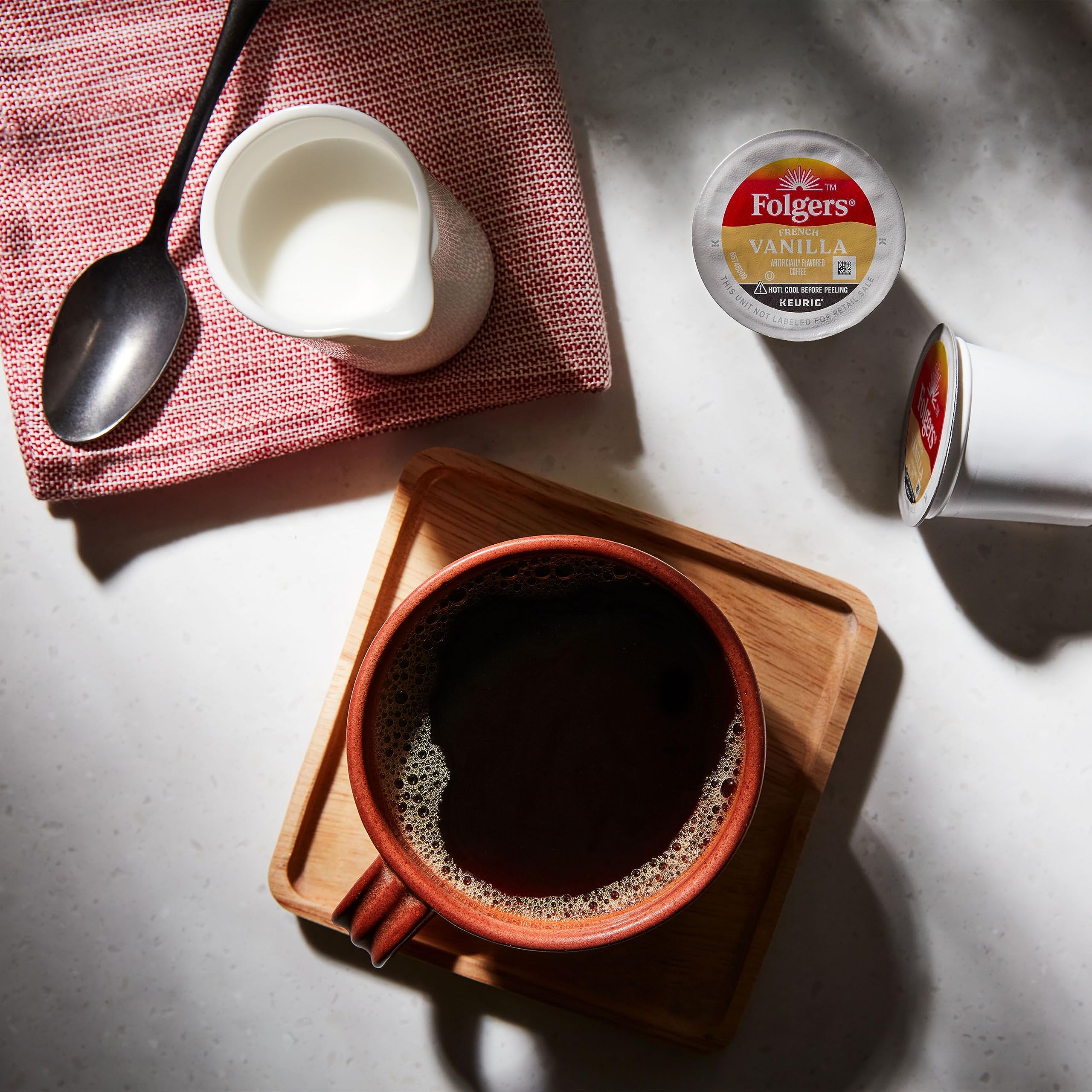 Mug of Folgers French Vanilla ready to be customized with creamer.