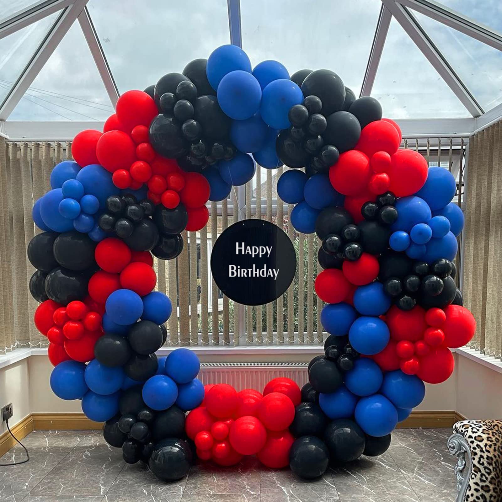 FOTIOMRG balloon garland on wall creates a dramatic party backdrop.