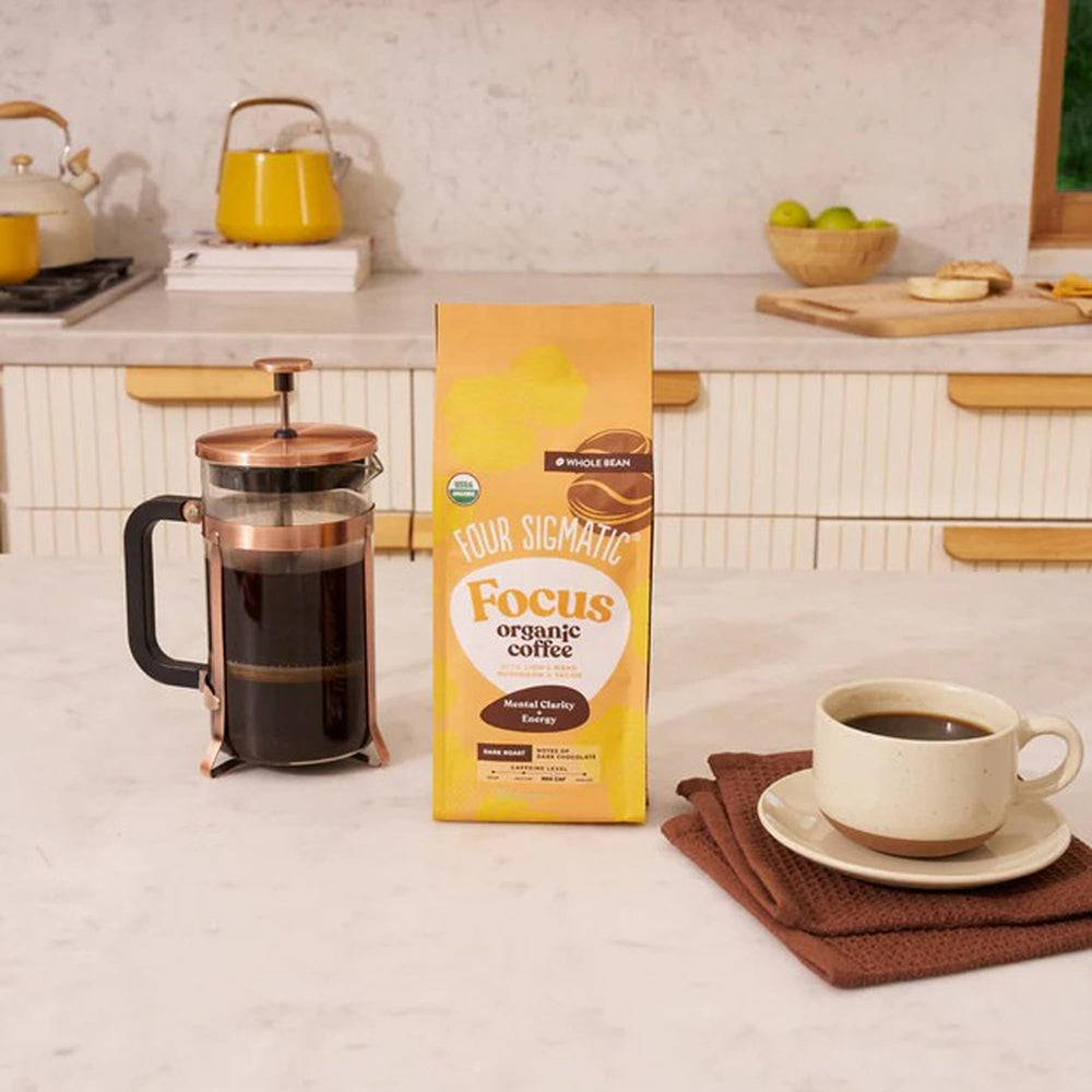 Close-up of a Four Sigmatic coffee cup showing crema and deep aroma