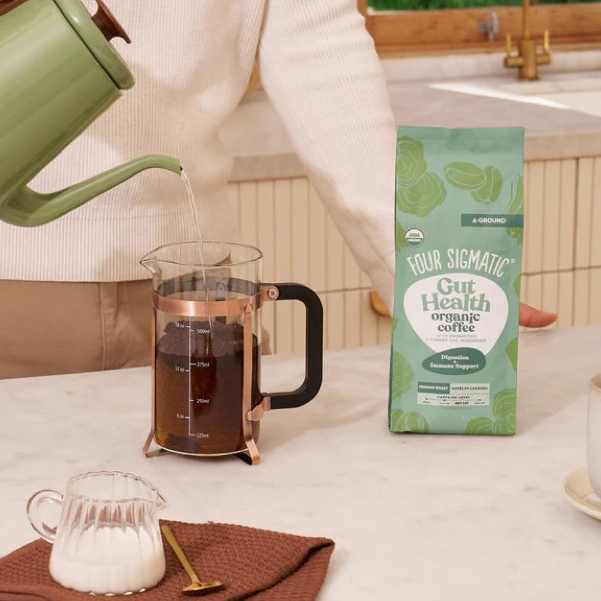 Ground beans and packaging of Four Sigmatic Gut Health Coffee for everyday use.
