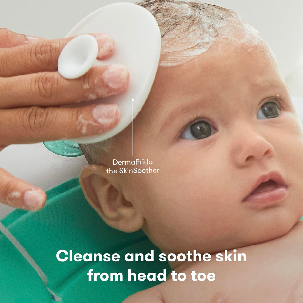Frida Baby DermaFrida SkinSoother brush with silicone carry case for bath time care.