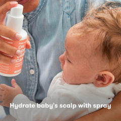Frida Baby FlakeFixer brush used to gently loosen flakes
