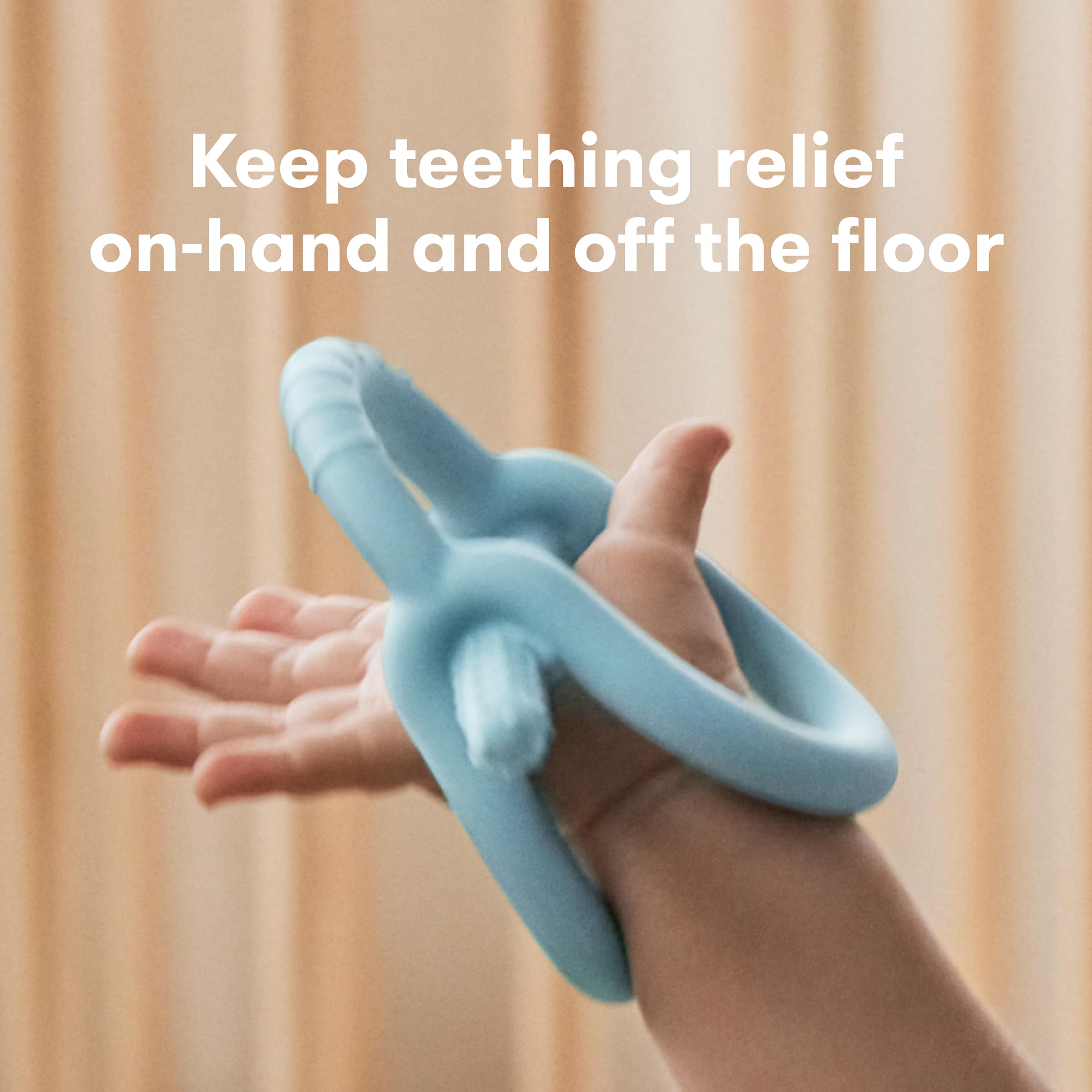 Frida Baby Get-A-Grip teether features wrist-hug design to prevent drops.
