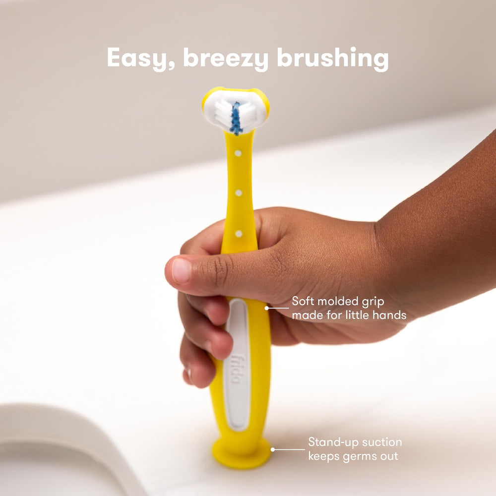 Frida Baby Triple-Angle Toothhugger supports learning proper brushing with caregiver guidance