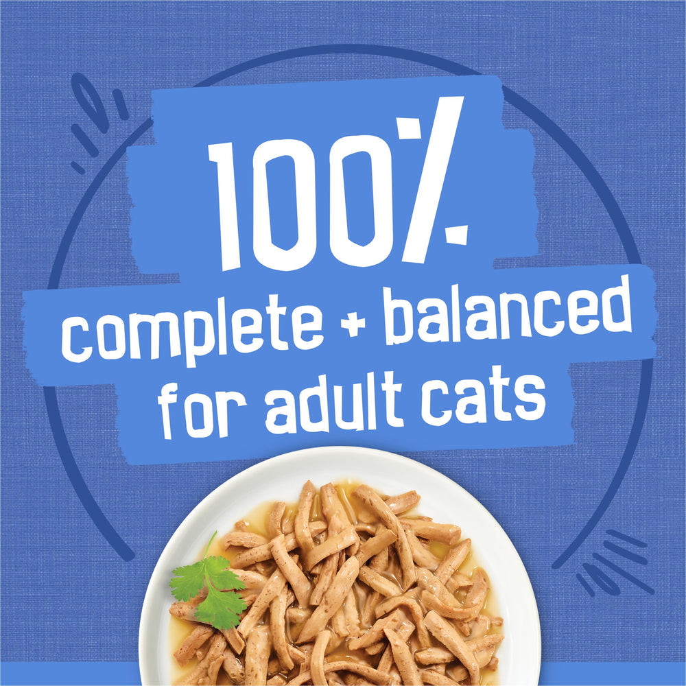 Friskies Shreds Ocean Whitefish and Tuna in Sauce close-up with flaky fish pieces and sauce.