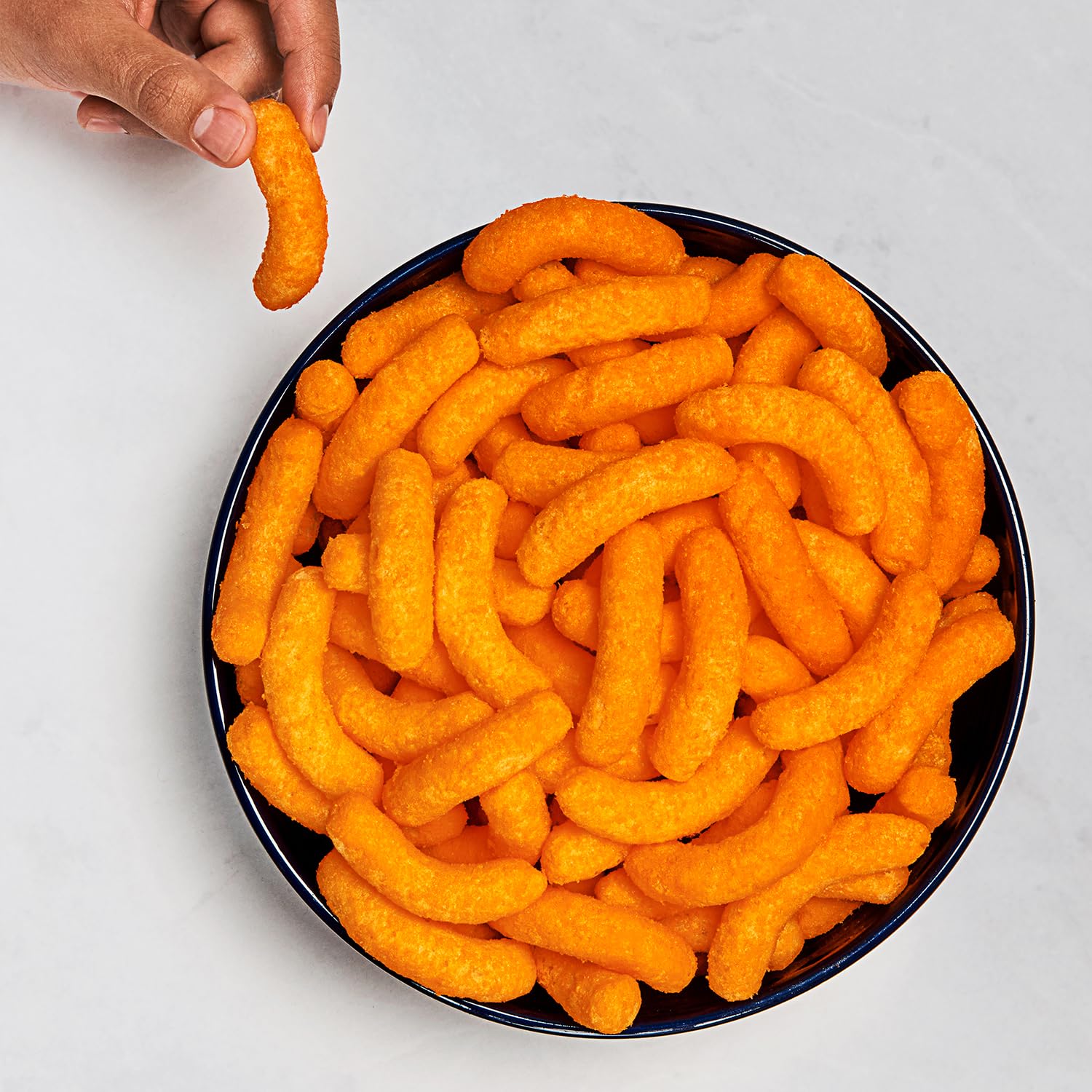Cheetos Puffs close-up emphasizing airy crunch and cheesy goodness