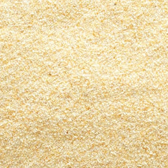 Frontier Co-op garlic granules scooped into a small bowl, ideal for quick seasoning.