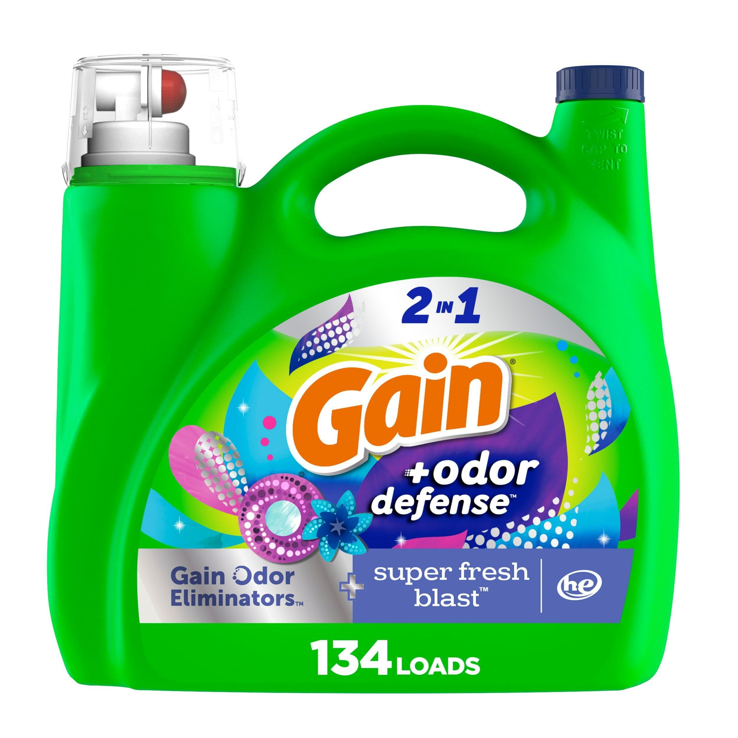 Gain Odor Defense bottle pouring for long-lasting freshness in laundry.