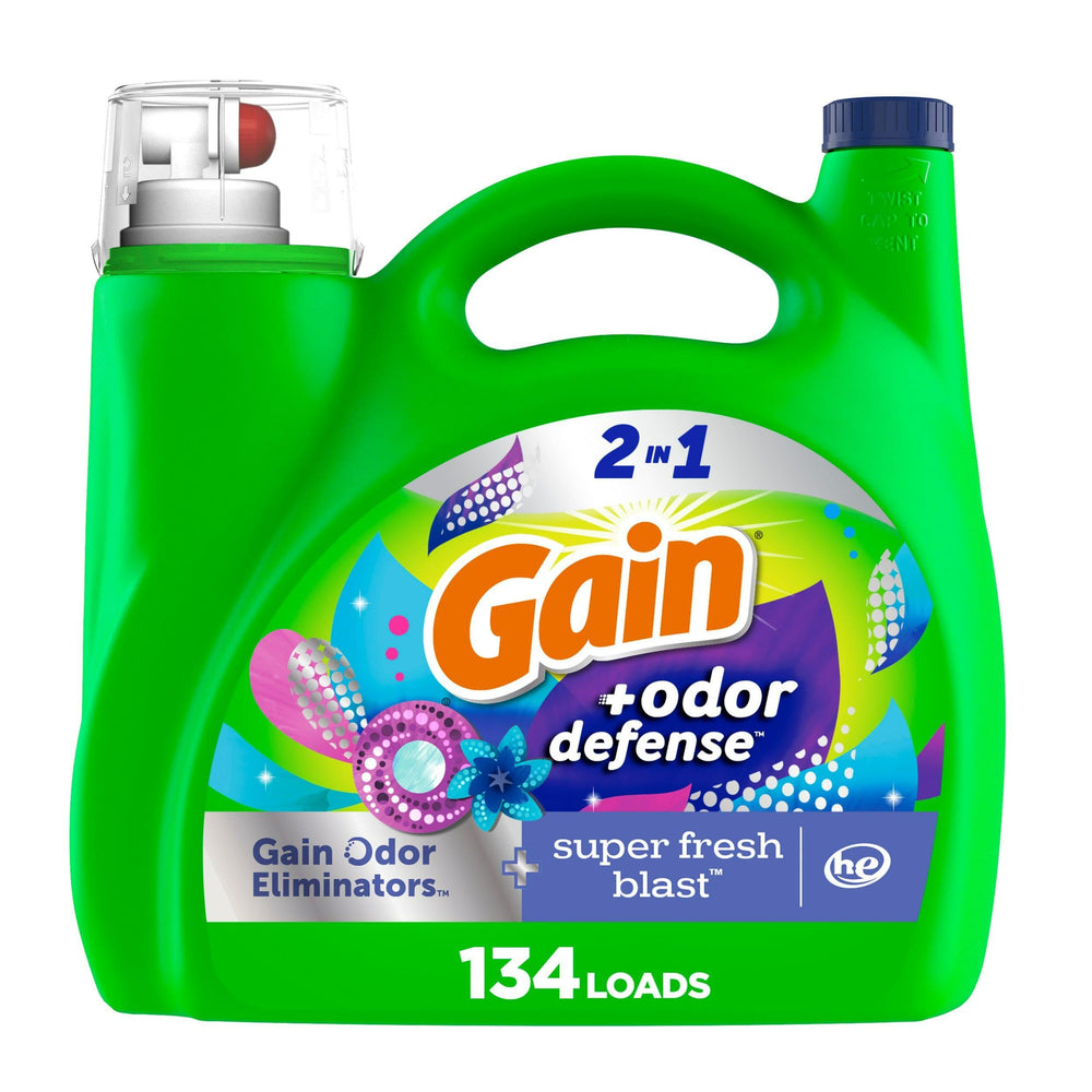 Gain Odor Defense bottle pouring for long-lasting freshness in laundry.