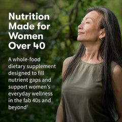 Garden of Life Organics Women 40+ bottle being poured for easy dosage.