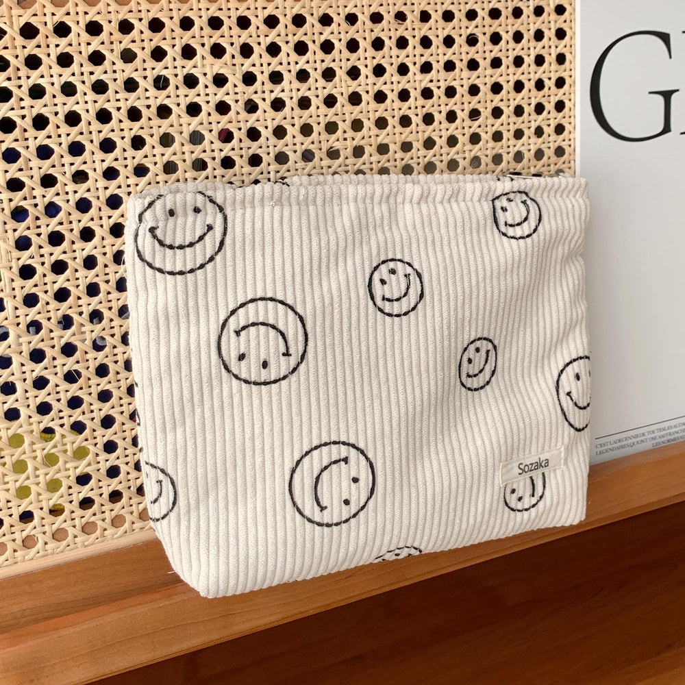 Gardsell corduroy bag open to reveal organized makeup, jewelry, and toiletries.