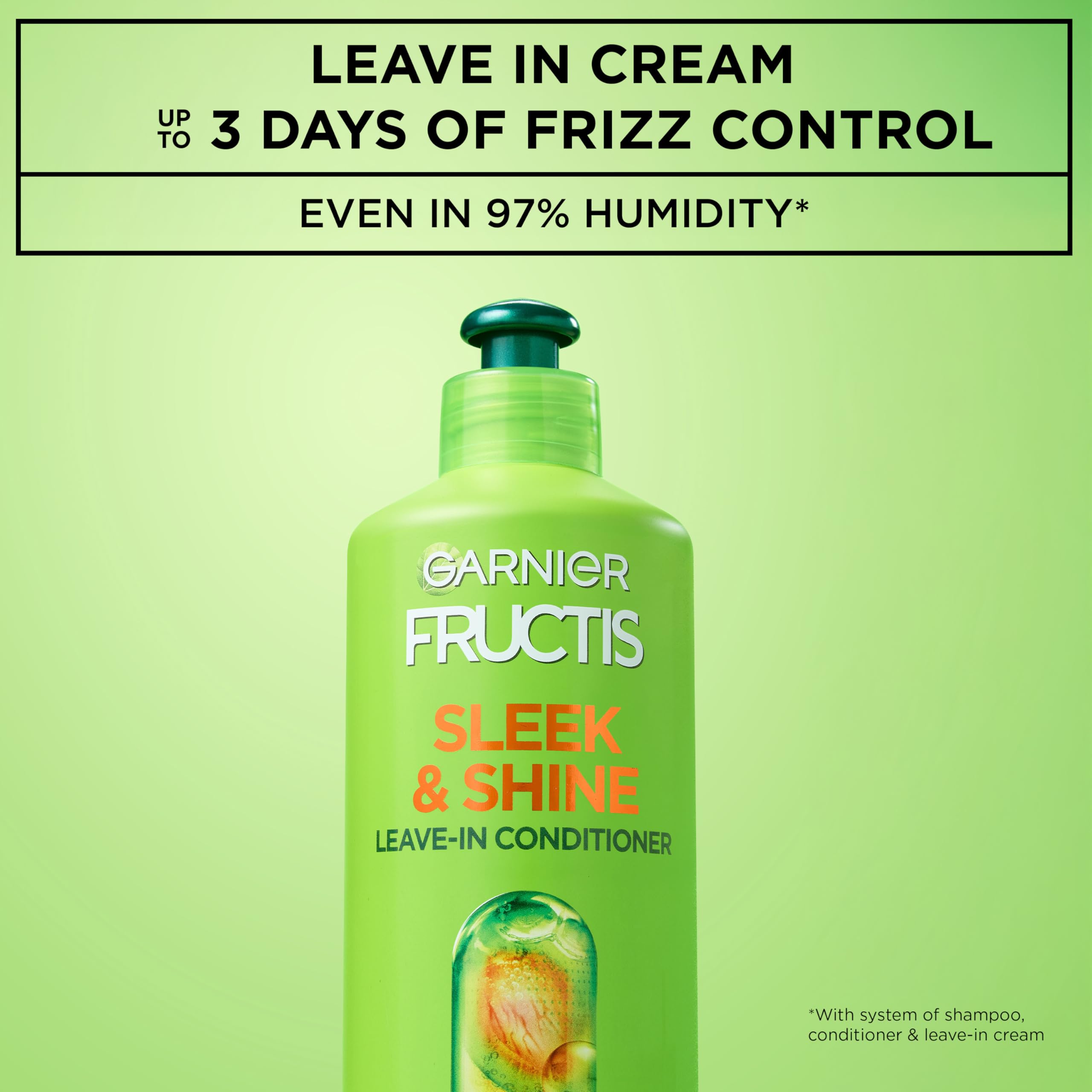 Garnier Fructis Sleek & Shine bottle pour demonstrates smoothing formula.