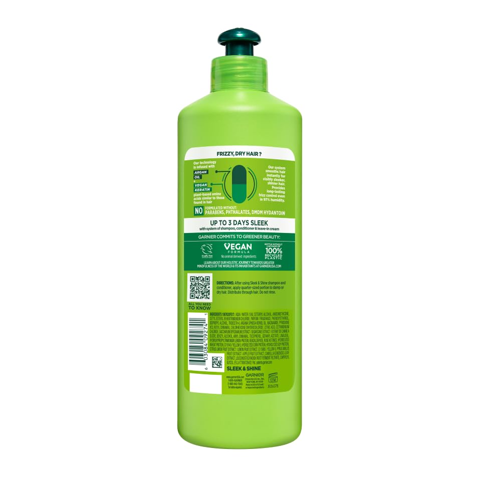 Garnier Fructis Sleek & Shine bottle beside a comb for styling.
