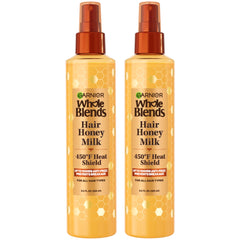 Garnier Whole Blends Hair Honey Milk bottle on display, honey-infused protection for styling.