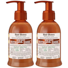 Garnier Whole Blends Honey Treasures Serum bottle close-up with eco-friendly recycled packaging.