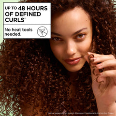 Garnier Fructis Curl Nourish Air Dry Cream being applied to damp hair to define curls