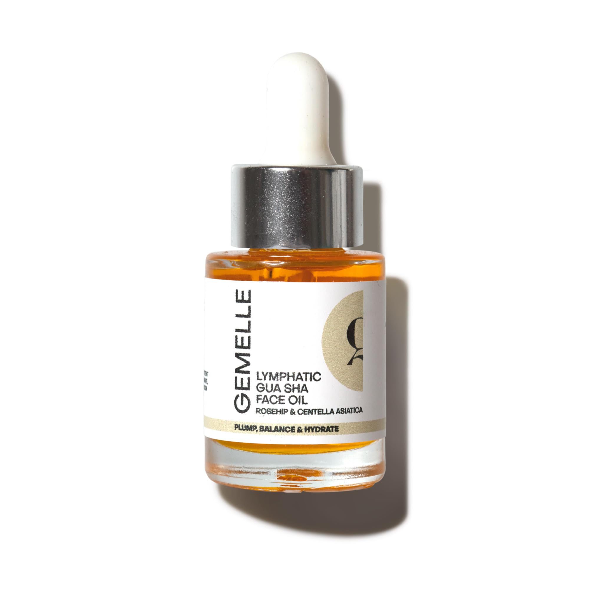Gemelle lymphatic gua sha face oil bottle glistening for smooth, hydrated skin.
