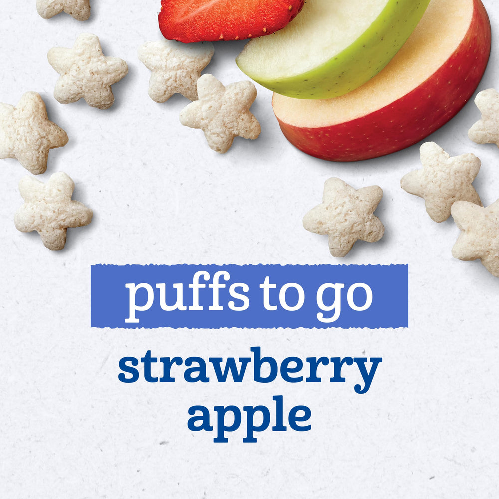 Gerber Puffs to Go Strawberry Apple held by a toddler's hand, easy bite-sized snack.