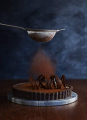 Ghirardelli Majestic Dutch Cocoa Powder ideal for hot beverages.