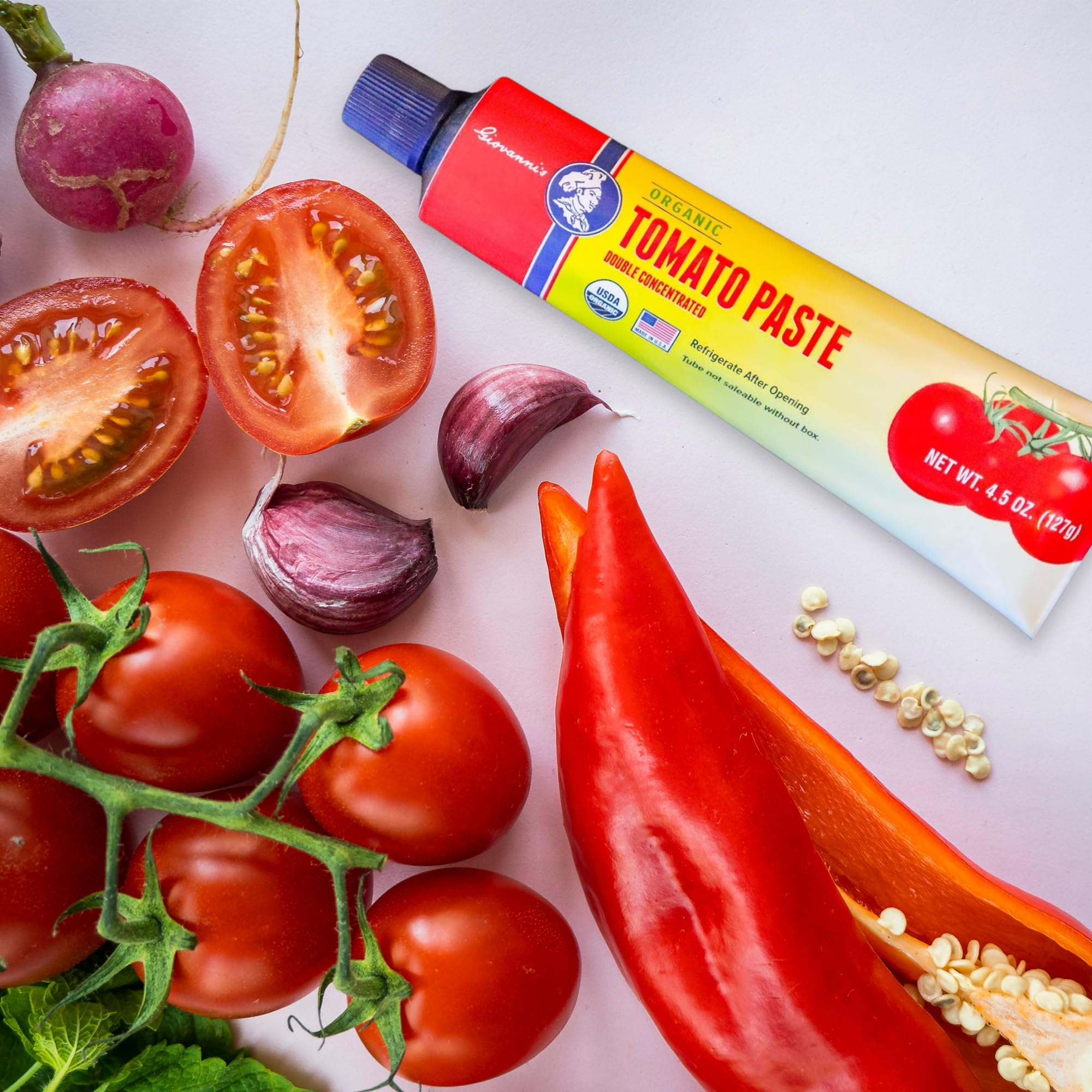 Giovanni's Organics paste close-up shows deep ruby color and smooth texture.