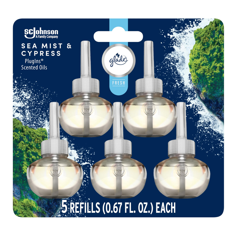 Glade PlugIns Sea Mist & Cypress bottle releasing long-lasting fragrance in the living room.